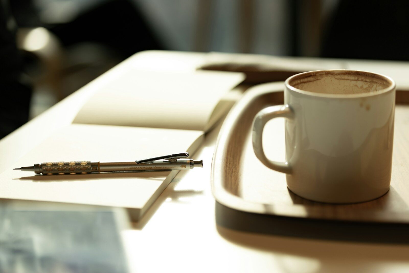 A cup of coffee sitting on top of a white plate